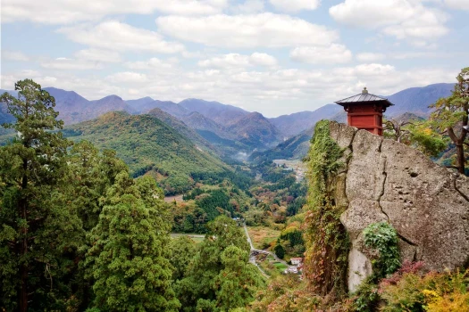 Japanese countryside with building overlooking a cliff face